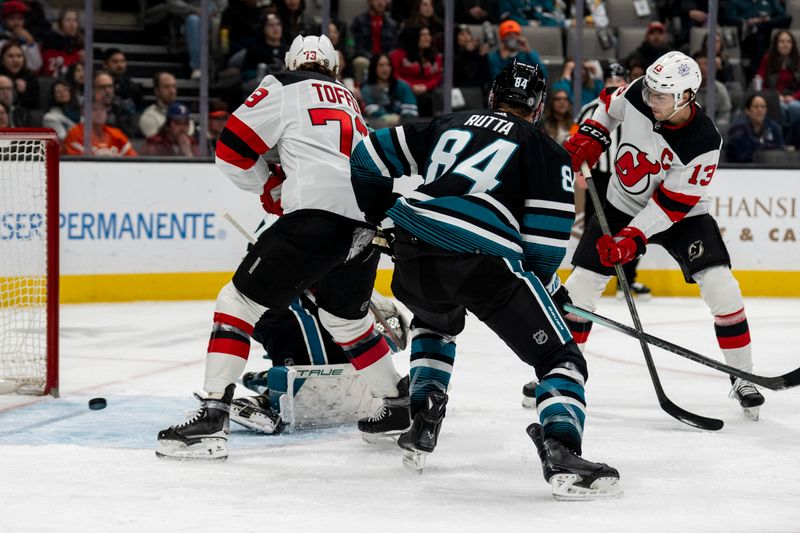 Feb 27, 2024; San Jose, California, USA;  New Jersey Devils center Nico Hischier (13) shot is deflected and saved by San Jose Sharks goaltender Mackenzie Blackwood (29) during the first period at SAP Center at San Jose. Mandatory Credit: Neville E. Guard-USA TODAY Sports