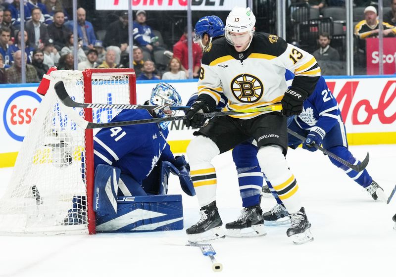 Nov 5, 2024; Toronto, Ontario, CAN; Boston Bruins center Charlie Coyle (13) battles in front of Toronto Maple Leafs goaltender Anthony Stolarz (41) after losing his goal stick during the second period at Scotiabank Arena. Mandatory Credit: Nick Turchiaro-Imagn Imagess