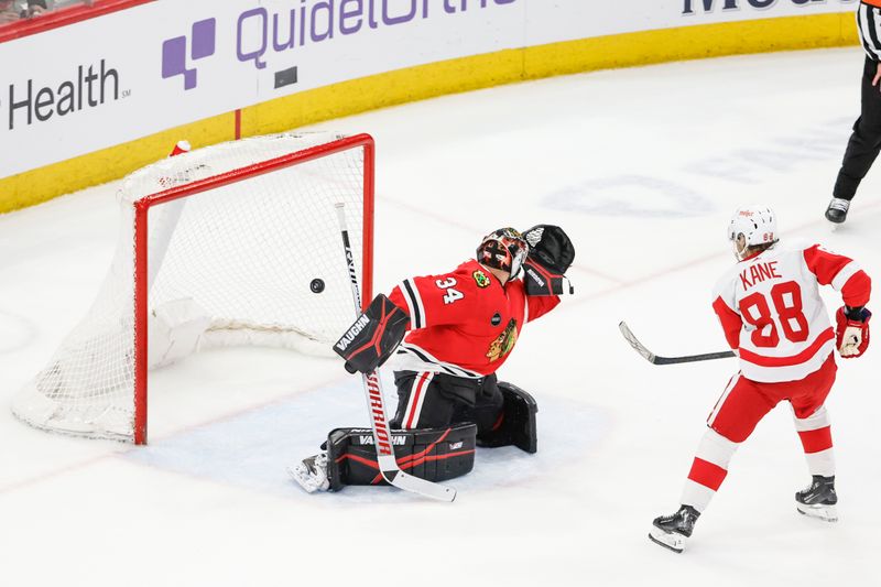 Feb 25, 2024; Chicago, Illinois, USA; Detroit Red Wings right wing Patrick Kane (88) scores game winning goal against Chicago Blackhawks goaltender Petr Mrazek (34) in overtime at United Center. Mandatory Credit: Kamil Krzaczynski-USA TODAY Sports