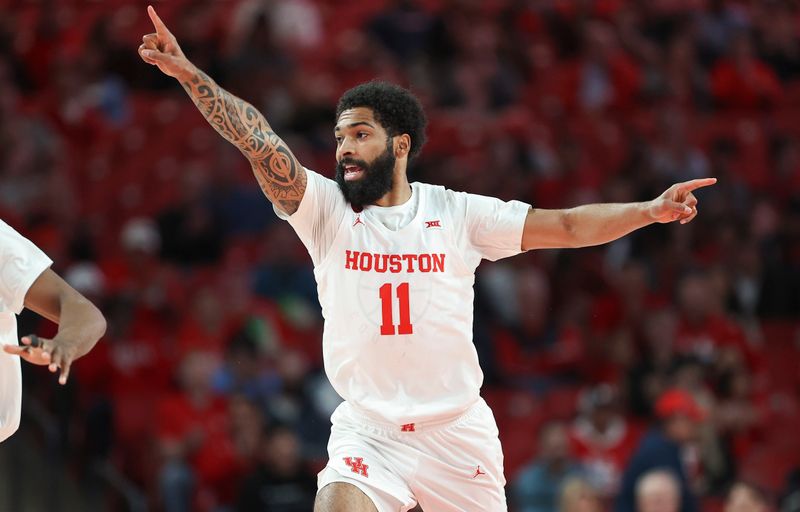 Dec 6, 2023; Houston, Texas, USA; Houston Cougars guard Damian Dunn (11) reacts after a play during the first half against the Rice Owls at Fertitta Center. Mandatory Credit: Troy Taormina-USA TODAY Sports