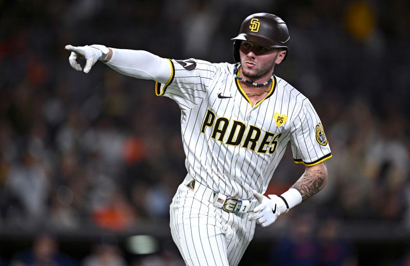 Sep 16, 2024; San Diego, California, USA; San Diego Padres center fielder Jackson Merrill (3) gestures toward the Padres dugout after hitting a home run against the Houston Astros during the fourth inning at Petco Park. Mandatory Credit: Orlando Ramirez-Imagn Images