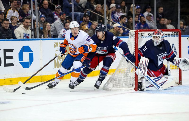 Nov 3, 2024; New York, New York, USA; New York Islanders center Casey Cizikas (53) tries to get by New York Rangers left wing Will Cuylle (50) during the second period at Madison Square Garden. Mandatory Credit: Danny Wild-Imagn Images