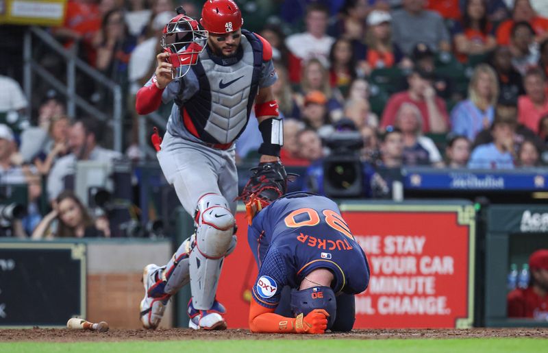 Jun 3, 2024; Houston, Texas, USA; St. Louis Cardinals catcher Ivan Herrera (48) reacts after Houston Astros right fielder Kyle Tucker (30) goes to the ground with an apparent injury during the third inning at Minute Maid Park. Mandatory Credit: Troy Taormina-USA TODAY Sports