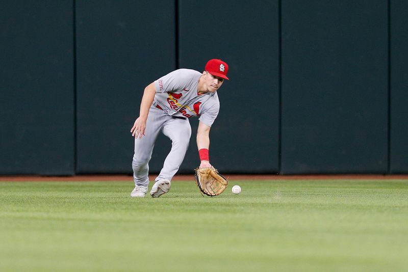 Jun 7, 2023; Arlington, Texas, USA; St. Louis Cardinals center fielder Tommy Edman (19) fields a ground ball during the third inning against the Texas Rangers at Globe Life Field. Mandatory Credit: Andrew Dieb-USA TODAY Sports