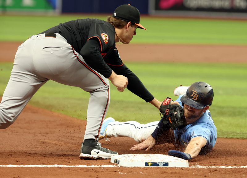 Aug 11, 2024; St. Petersburg, Florida, USA; Baltimore Orioles third base Coby Mayo (16) tags out Tampa Bay Rays designated hitter Brandon Lowe (8) at third base during the third inning at Tropicana Field. Mandatory Credit: Kim Klement Neitzel-USA TODAY Sports