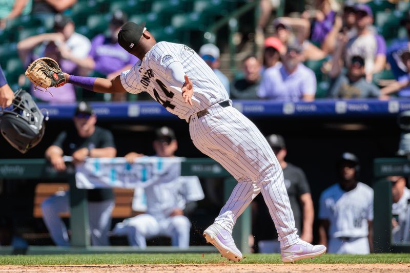 Jun 5, 2024; Denver, Colorado, USA; Colorado Rockies first base Elehuris Montero (44) reaches to catch for an out during the fifth inning against the Cincinnati Reds at Coors Field. Mandatory Credit: Andrew Wevers-USA TODAY Sports