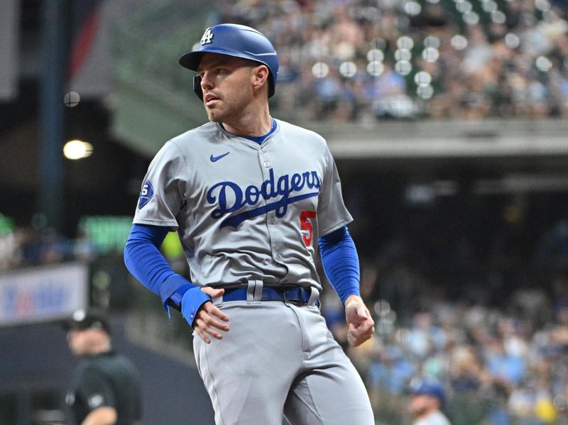 Aug 14, 2024; Milwaukee, Wisconsin, USA; Los Angeles Dodgers first base Freddie Freeman (5) runs to third on a  second base Gavin Lux (9) double agaisnt the Milwaukee Brewers in the fifth inning  at American Family Field. Mandatory Credit: Michael McLoone-USA TODAY Sports