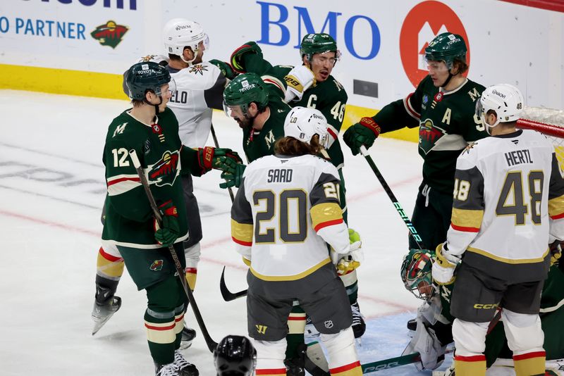 Apr 26, 2025; Saint Paul, Minnesota, USA; Minnesota Wild defenseman Jared Spurgeon (46) takes a punch from Vegas Golden Knights defenseman Alex Pietrangelo (7) during 1st OT in game four of the first round of the 2025 Stanley Cup Playoffs at Xcel Energy Center. Mandatory Credit: Bruce Fedyck-Imagn Images