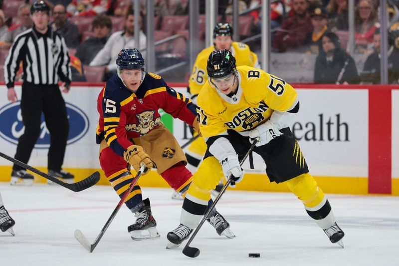 Feb 4, 2026; Sunrise, Florida, USA; ]Boston Bruins center Matthew Poitras (51) moves the puck against Florida Panthers center Anton Lundell (15) during the first period at Amerant Bank Arena. Mandatory Credit: Sam Navarro-Imagn Images
