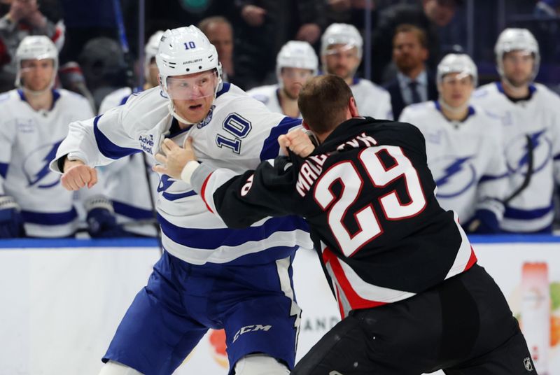 Mar 8, 2026; Buffalo, New York, USA;  Tampa Bay Lightning right wing Corey Perry (10) and Buffalo Sabres left wing Beck Malenstyn (29) fight during the second period at KeyBank Center. Mandatory Credit: Timothy T. Ludwig-Imagn Images