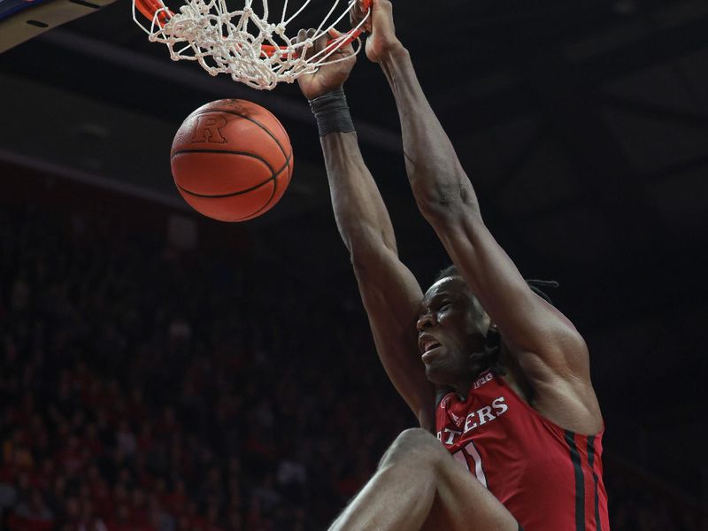 Mar 5, 2023; Piscataway, New Jersey, USA; Rutgers Scarlet Knights center Clifford Omoruyi (11) dunks the ball in front of Rutgers Scarlet Knights forward Antwone Woolfolk (13) during the second half at Jersey Mike's Arena. Mandatory Credit: Vincent Carchietta-USA TODAY Sports