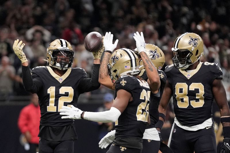 New Orleans Saints wide receiver Chris Olave (12) celebrates a touchdown in the second half of an NFL football game against the Atlanta Falcons in New Orleans, Sunday, Jan. 7, 2024. (AP Photo/Gerald Herbert)