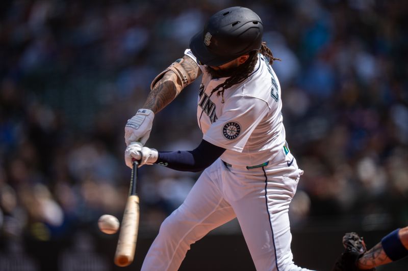 Apr 9, 2025; Seattle, Washington, USA;  Seattle Mariners shortstop J.P. Crawford (3) hits a double during the third inning against the Houston Astros at T-Mobile Park. Mandatory Credit: Stephen Brashear-Imagn Images