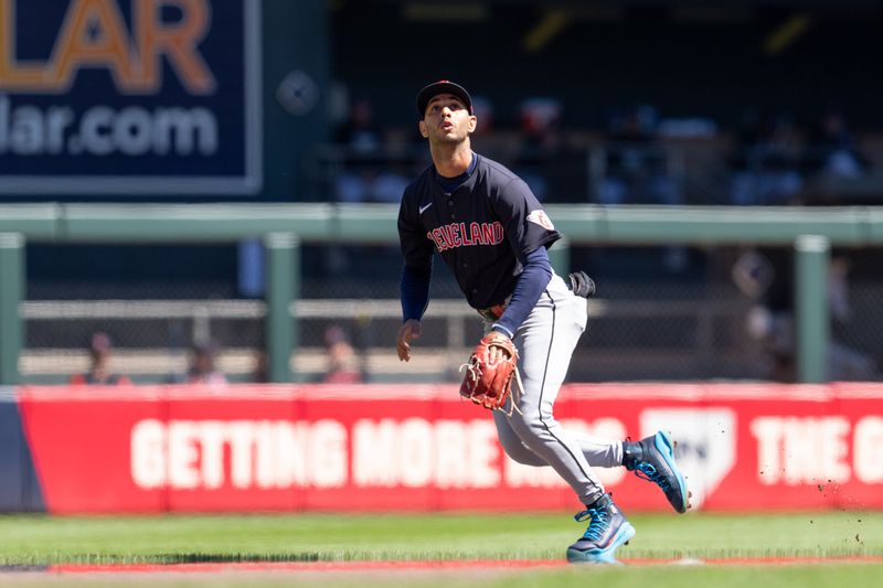 Apr 6, 2024; Minneapolis, Minnesota, USA; Cleveland Guardians shortstop Brayan Rocchio (4) tracks a fly ball from Minnesota Twins first base Alex Kirilloff (19) that would go foul in the first inning at Target Field. Mandatory Credit: Matt Blewett-USA TODAY Sports