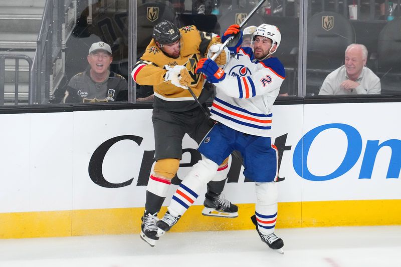 May 6, 2025; Las Vegas, Nevada, USA; Vegas Golden Knights left wing Tanner Pearson (70) checks Edmonton Oilers defenseman Evan Bouchard (2) during the third period of game one of the second round of the 2025 Stanley Cup Playoffs at T-Mobile Arena. Mandatory Credit: Stephen R. Sylvanie-Imagn Images