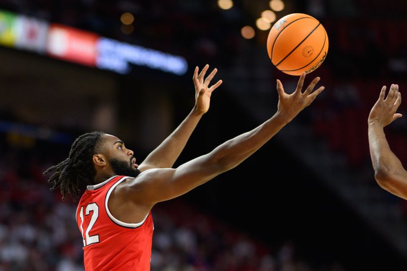 Dec 4, 2024; College Park, Maryland, USA; Ohio State Buckeyes guard Evan Mahaffey (12) reaches for a rebound during the second half against the Maryland Terrapins at Xfinity Center. Mandatory Credit: Reggie Hildred-Imagn Images