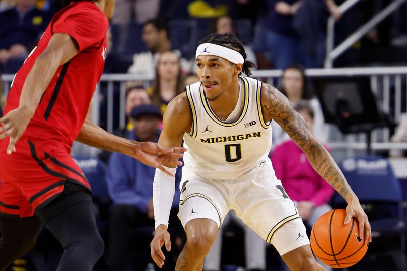 Feb 3, 2024; Ann Arbor, Michigan, USA;  Michigan Wolverines guard Dug McDaniel (0) dribbles in the first half against the Rutgers Scarlet Knights at Crisler Center. Mandatory Credit: Rick Osentoski-USA TODAY Sports