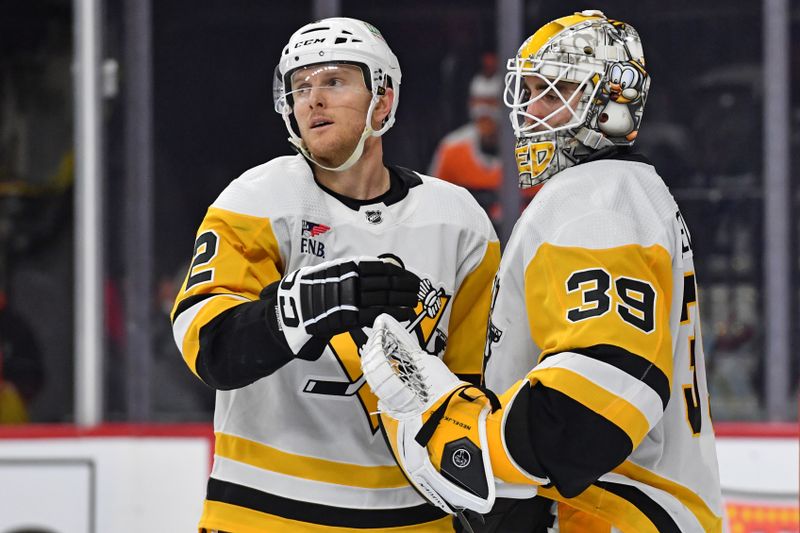 Jan 8, 2024; Philadelphia, Pennsylvania, USA; Pittsburgh Penguins defenseman Chad Ruhwedel (2) and goaltender Alex Nedeljkovic (39) celebrate win   against the Philadelphia Flyers at Wells Fargo Center. Mandatory Credit: Eric Hartline-USA TODAY Sports