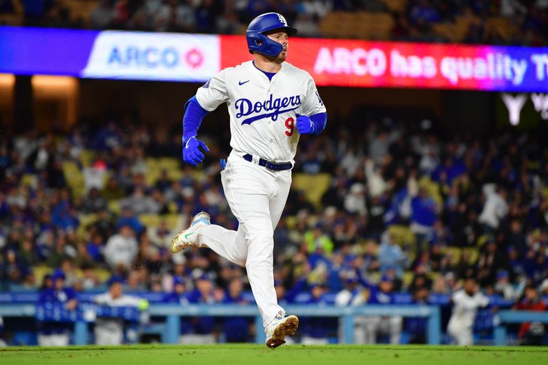 Apr 13, 2024; Los Angeles, California, USA; Los Angeles Dodgers second baseman Gavin Lux (9) runs after hitting an RBI single against the San Diego Padres during the sixth inning at Dodger Stadium. Mandatory Credit: Gary A. Vasquez-USA TODAY Sports