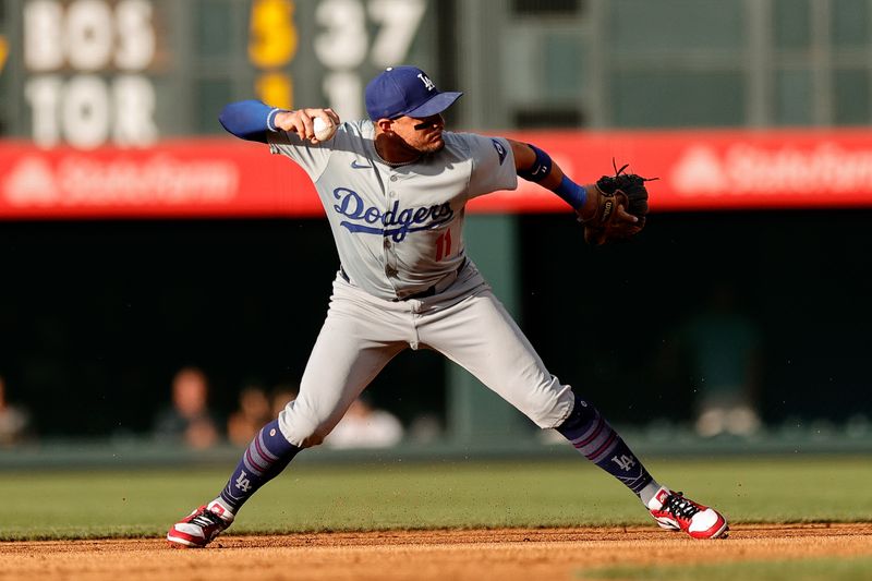 Jun 17, 2024; Denver, Colorado, USA; Los Angeles Dodgers shortstop Miguel Rojas (11) fields and throws to first for an out in the first inning against the Colorado Rockies at Coors Field. Mandatory Credit: Isaiah J. Downing-USA TODAY Sports