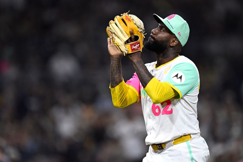 Jun 21, 2024; San Diego, California, USA; San Diego Padres relief pitcher Enyel De Los Santos (62) reacts after an inning-ending double play during the eighth inning against the Milwaukee Brewers at Petco Park. Mandatory Credit: Orlando Ramirez-USA TODAY Sports