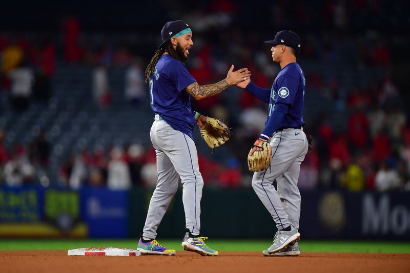 Aug 30, 2024; Anaheim, California, USA; Seattle Mariners shortstop J.P. Crawford (3) and second baseman Leo Rivas (76) celebrate the victory against the Los Angeles Angels at Angel Stadium. Mandatory Credit: Gary A. Vasquez-USA TODAY Sports