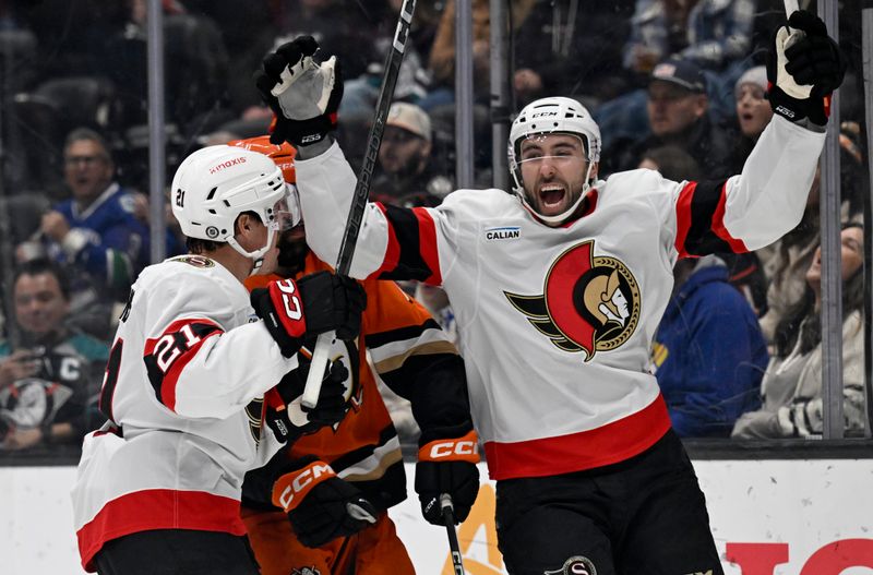 Dec 1, 2024; Anaheim, California, USA;  Ottawa Senators right wing Michael Amadio (right), celebrates a goal by center Nick Cousins (21) against Anaheim Ducks defenseman Radko Gudas (7) during the third period at Honda Center. Mandatory Credit: Alex Gallardo-Imagn Images