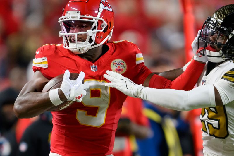 Kansas City Chiefs wide receiver JuJu Smith-Schuster (9) is forced out of bounds after a first down by New Orleans Saints cornerback Paulson Adebo (29) during the first half of an NFL football game, Monday, Oct. 7, 2024 in Kansas City, Mo. (AP Photo/Reed Hoffmann)