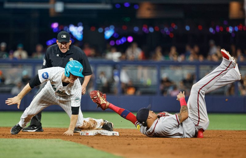 Sep 15, 2023; Miami, Florida, USA; Miami Marlins shortstop Joey Wendle (18) is out at second base on a fielders choice tag by Atlanta Braves shortstop Orlando Arcia (11) during the fourth ining at loanDepot Park. Mandatory Credit: Rhona Wise-USA TODAY Sports