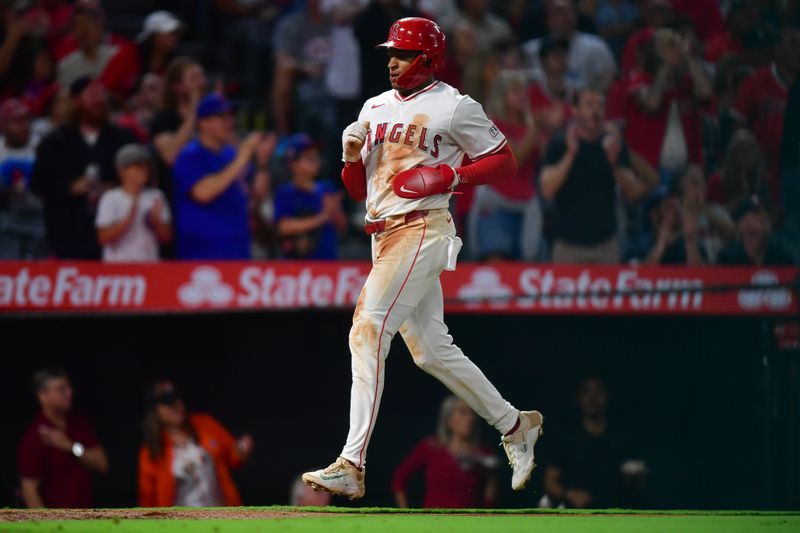 Sep 26, 2025; Anaheim, California, USA; Los Angeles Angels second baseman Christian Moore (4) scores a run against the Houston Astros during the fifth inning at Angel Stadium. Mandatory Credit: Gary A. Vasquez-Imagn Images