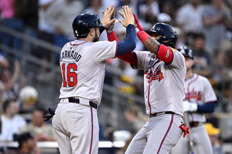 Jul 12, 2024; San Diego, California, USA; Atlanta Braves shortstop Orlando Arcia (right) is congratulated by catcher Travis d'Arnaud (16) after hitting a two-run home run against the San Diego Padres during the fifth inning at Petco Park. Mandatory Credit: Orlando Ramirez-USA TODAY Sports 