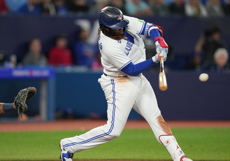 Sep 29, 2023; Toronto, Ontario, CAN; Toronto Blue Jays first baseman Vladimir Guerrero Jr. (27) hits a double against the Tampa Bay Rays during the sixth inning at Rogers Centre. Mandatory Credit: Nick Turchiaro-USA TODAY Sports