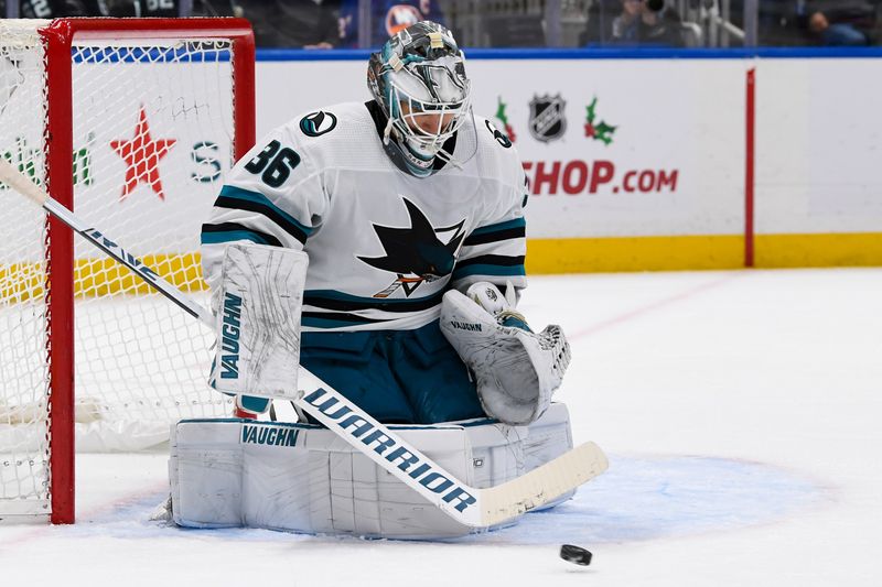 Dec 5, 2023; Elmont, New York, USA; San Jose Sharks goaltender Kaapo Kahkonen (36) makes a save against New York Islanders during the second period at UBS Arena. Mandatory Credit: Dennis Schneidler-USA TODAY Sports