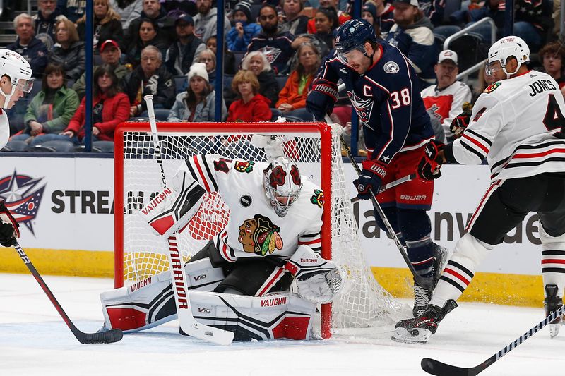 Nov 22, 2023; Columbus, Ohio, USA; Columbus Blue Jackets center Boone Jenner (38) scores against Chicago Blackhawks goalie Petr Mrazek (34) during the first period at Nationwide Arena. Mandatory Credit: Russell LaBounty-USA TODAY Sports