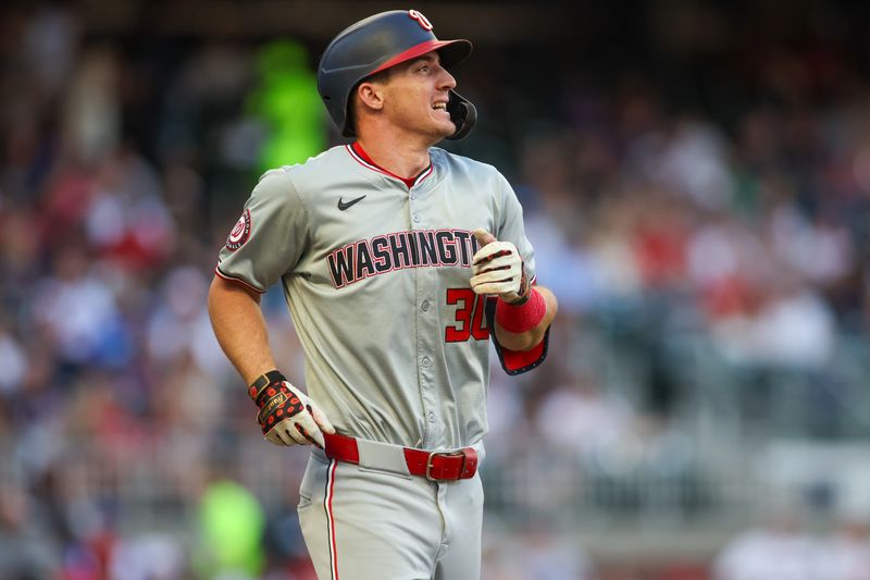 May 30, 2024; Atlanta, Georgia, USA; Washington Nationals center fielder Jacob Young (30) reacts after being hit by a pitch against the Atlanta Braves in the third inning at Truist Park. Mandatory Credit: Brett Davis-USA TODAY Sports