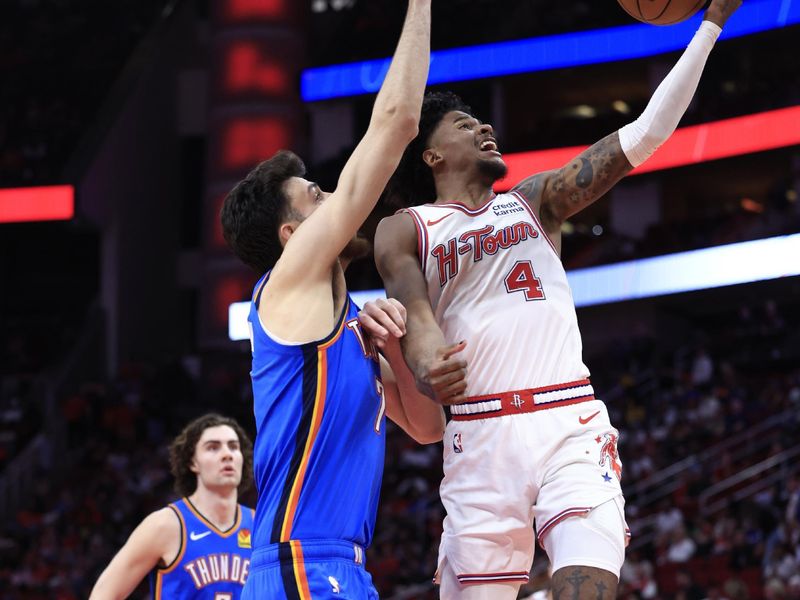 HOUSTON, TEXAS - FEBRUARY 25: Jalen Green #4 of the Houston Rockets drives to the net ahead of Chet Holmgren #7 of the Oklahoma City Thunder during the second  half at Toyota Center on February 25, 2024 in Houston, Texas. NOTE TO USER: User expressly acknowledges and agrees that, by downloading and or using this photograph, User is consenting to the terms and conditions of the Getty Images License Agreement. (Photo by Carmen Mandato/Getty Images)