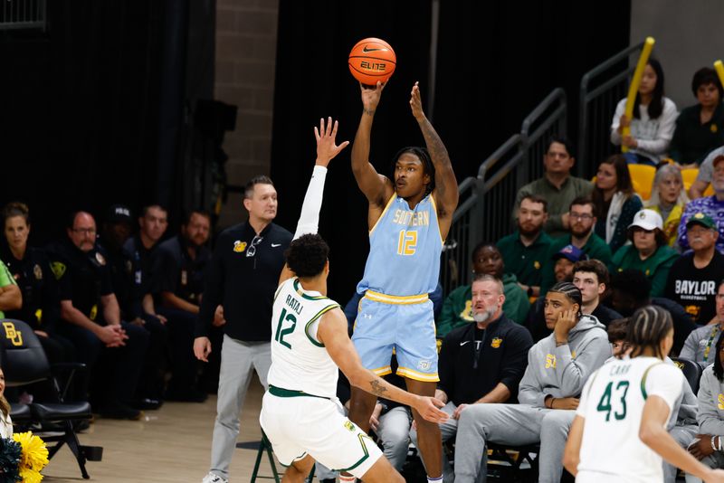 Dec 21, 2025; Waco, Texas, USA; Southern University Jaguars forward AJ Barnes (12) shoots as Baylor Bears guard Michael Rataj (12) defends during the first half at Paul and Alejandra Foster Pavilion. Mandatory Credit: Chris Jones-Imagn Images