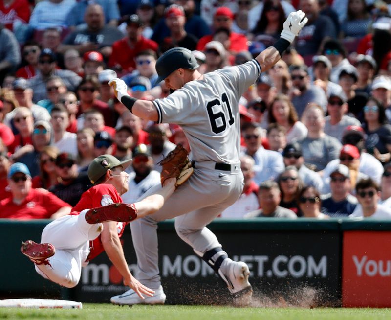 May 20, 2023; Cincinnati, Ohio, USA; New York Yankees right fielderJake Bauers (61) is tagged out at first by Cincinnati Reds first baseman Spencer Steer (7) during the second inning at Great American Ball Park. Mandatory Credit: David Kohl-USA TODAY Sports