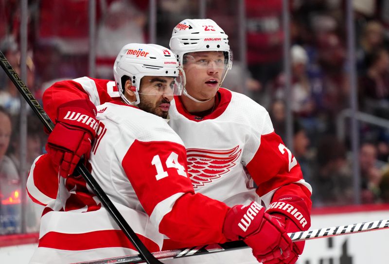 Mar 6, 2024; Denver, Colorado, USA; Detroit Red Wings center Robby Fabbri (14) celebrates his goal with left wing Lucas Raymond (23) in the first period at Ball Arena. Mandatory Credit: Ron Chenoy-USA TODAY Sports