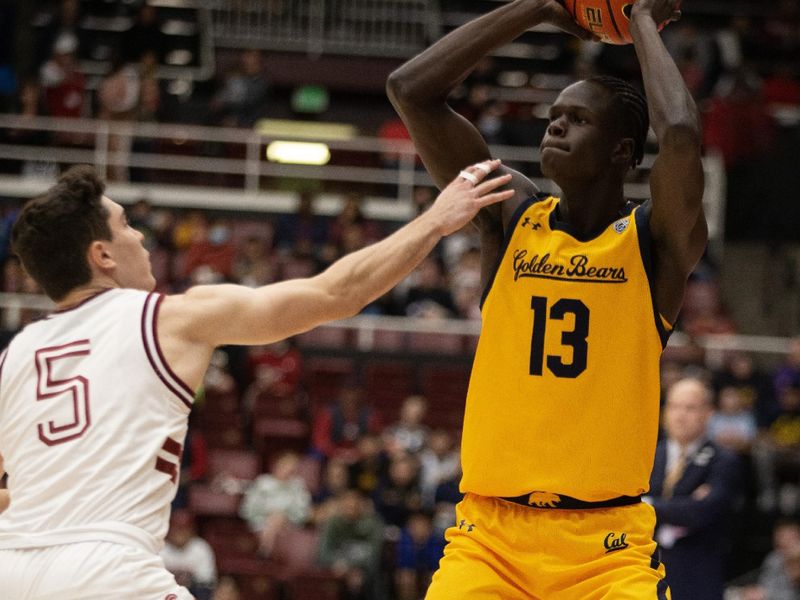 Jan 28, 2023; Stanford, California, USA; California Golden Bears forward Kuany Kuany (13) looks to pass over Stanford Cardinal guard Michael O'Connell (5) during the first half at Maples Pavilion. Mandatory Credit: D. Ross Cameron-USA TODAY Sports