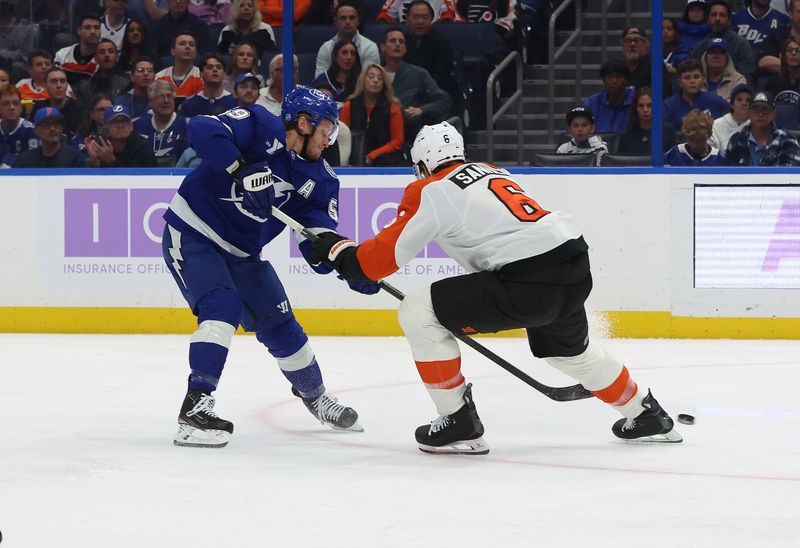 Nov 24, 2025; Tampa, Florida, USA; Tampa Bay Lightning center Jake Guentzel (59) shoots as Philadelphia Flyers defenseman Travis Sanheim (6) defends during the first period at Benchmark International Arena. Mandatory Credit: Kim Klement Neitzel-Imagn Images