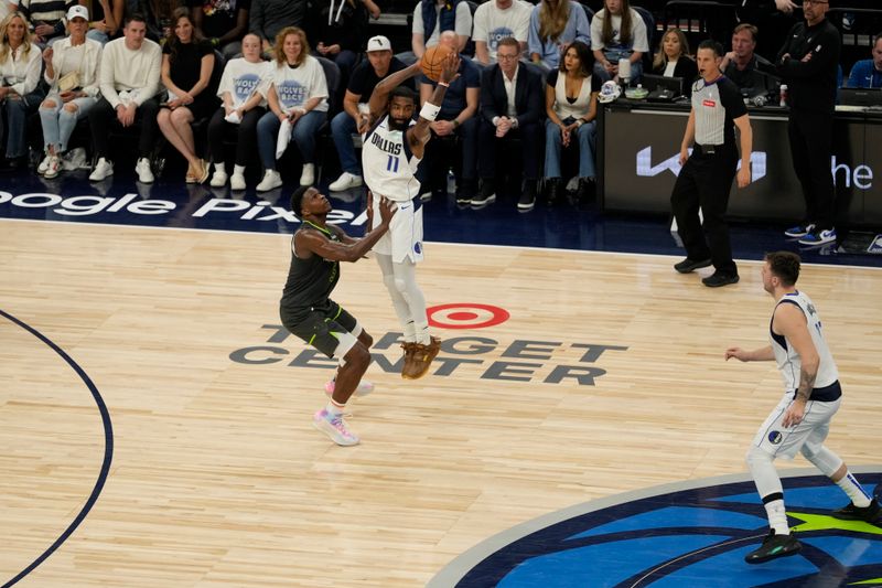 MINNEAPOLIS, MN - MAY 30: Kyrie Irving #11 of the Dallas Mavericks passes the ball during the game against the Minnesota Timberwolves during Game 5 of the Western Conference Finals of the 2024 NBA Playoffs on May 30, 2024 at Target Center in Minneapolis, Minnesota. NOTE TO USER: User expressly acknowledges and agrees that, by downloading and or using this Photograph, user is consenting to the terms and conditions of the Getty Images License Agreement. Mandatory Copyright Notice: Copyright 2024 NBAE (Photo by Jordan Johnson/NBAE via Getty Images)