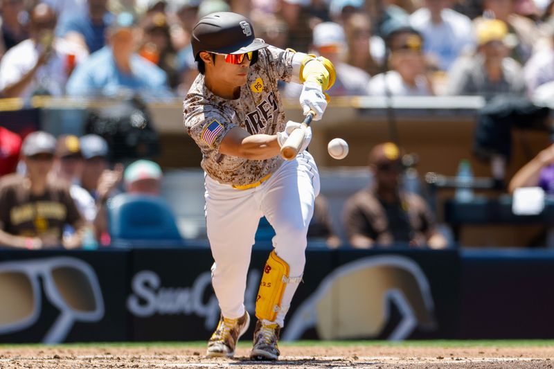 Aug 4, 2024; San Diego, California, USA;  San Diego Padres shortstop Ha-Seong Kim (7) hits a sacrifice bunt during the second inning against the Colorado Rockies at Petco Park. Mandatory Credit: David Frerker-USA TODAY Sports