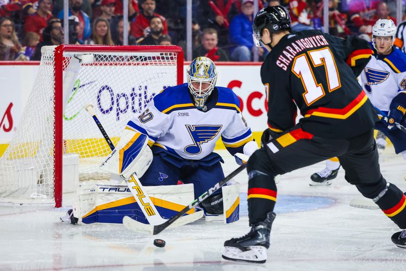 Jan 23, 2024; Calgary, Alberta, CAN; St. Louis Blues goaltender Jordan Binnington (50) guards his net against Calgary Flames center Yegor Sharangovich (17) during the second period at Scotiabank Saddledome. Mandatory Credit: Sergei Belski-USA TODAY Sports