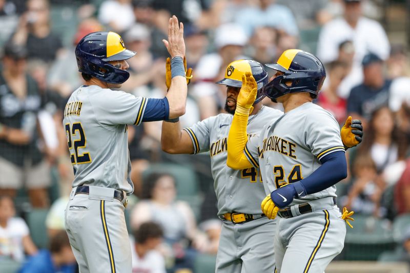 Aug 13, 2023; Chicago, Illinois, USA; Milwaukee Brewers first baseman Carlos Santana (41) celebrates with catcher William Contreras (24) and left fielder Christian Yelich (22) after hitting a three-run home run against the Chicago White Sox during the eight inning at Guaranteed Rate Field. Mandatory Credit: Kamil Krzaczynski-USA TODAY Sports