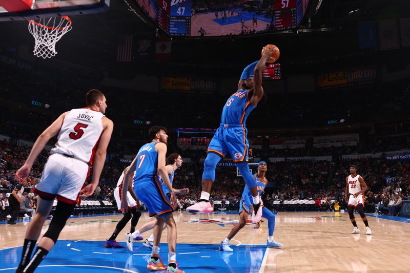 OKLAHOMA CITY, OK - MARCH 8:  Luguentz Dort #5 of the Oklahoma City Thunder grabs a rebound during the game against the Miami Heat on March 8, 2024 at Paycom Arena in Oklahoma City, Oklahoma. NOTE TO USER: User expressly acknowledges and agrees that, by downloading and or using this photograph, User is consenting to the terms and conditions of the Getty Images License Agreement. Mandatory Copyright Notice: Copyright 2024 NBAE (Photo by Zach Beeker/NBAE via Getty Images)