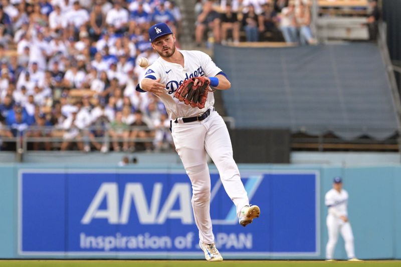 Oct 11, 2024; Los Angeles, California, USA; Los Angeles Dodgers third baseman Max Muncy (13) throws out San Diego Padres outfielder Jackson Merrill (not pictured) in the second inning during game five of the NLDS for the 2024 MLB Playoffs at Dodger Stadium. Mandatory Credit: Jayne Kamin-Oncea-Imagn Images