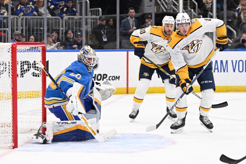 Feb 17, 2024; St. Louis, Missouri, USA; St. Louis Blues goaltender Jordan Binnington (50) defends the net from Nashville Predators center Ryan O'Reilly (90) and center Cody Glass (8) during the third period at Enterprise Center. Mandatory Credit: Jeff Le-USA TODAY Sports