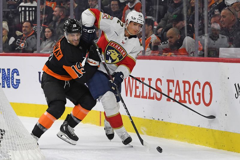 Jan 13, 2025; Philadelphia, Pennsylvania, USA; Florida Panthers defenseman Gustav Forsling (42) and Philadelphia Flyers right wing Garnet Hathaway (19) battle for the puck during the first period at Wells Fargo Center. Mandatory Credit: Eric Hartline-Imagn Images