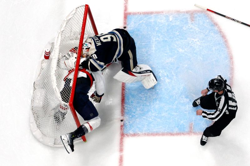 Dec 21, 2023; Columbus, Ohio, USA; Washington Capitals right wing Tom Wilson (43) and Columbus Blue Jackets goalie Elvis Merzlikins (90) battle inside the goals during overtime at Nationwide Arena. Mandatory Credit: Russell LaBounty-USA TODAY Sports